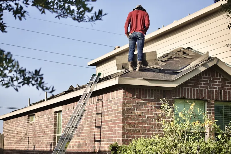 Professional roofer working on a residential roof in Rivers Bend